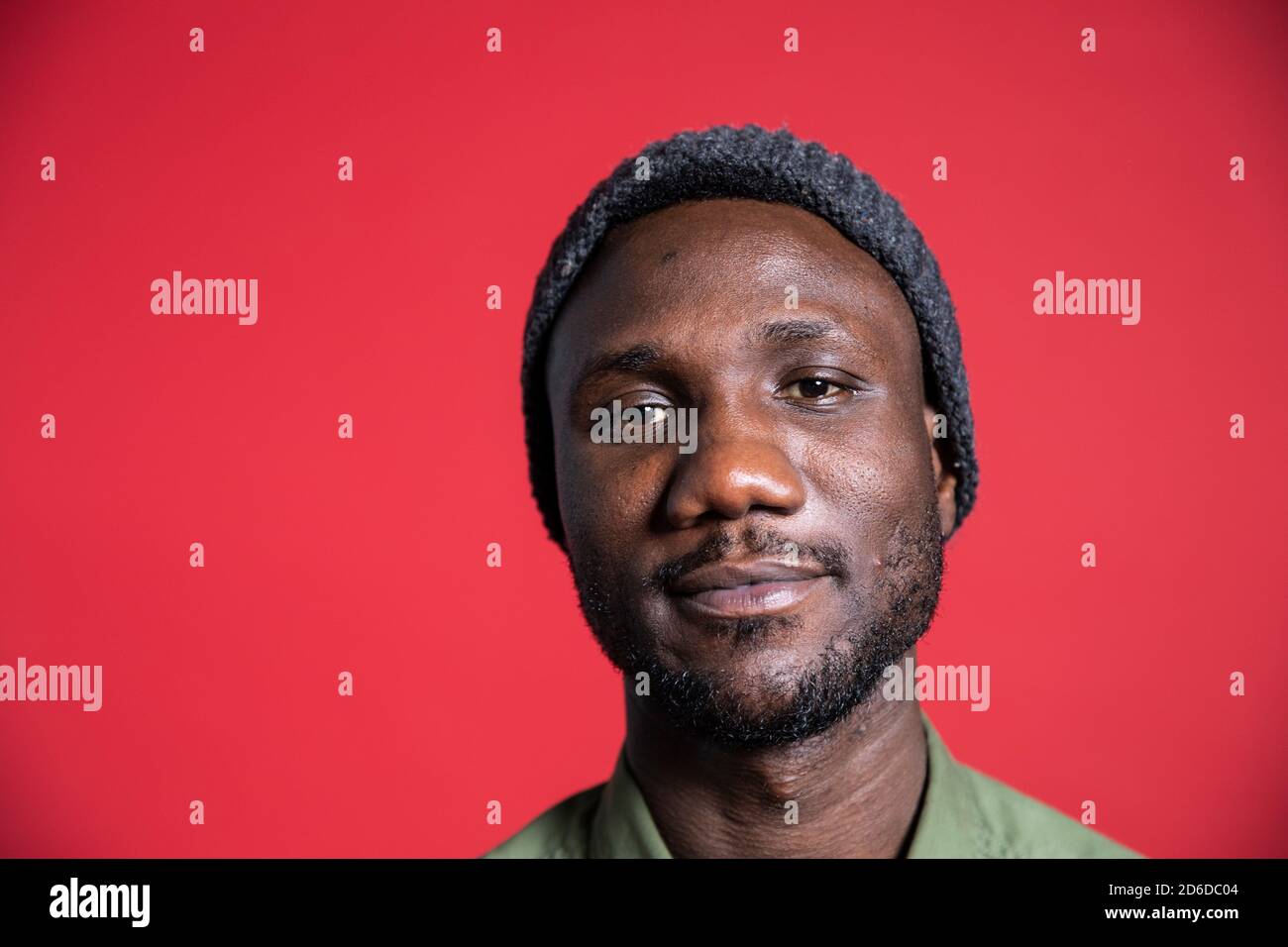 Face portrait of young black man looking at camera. Close up. Isolated background. Copy space. Stock Photo