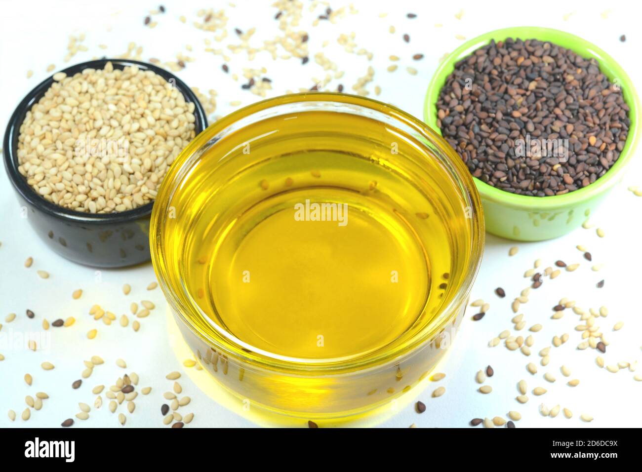 Sesame oil in a glass cup with sesame black and white seeds in a cup Stock Photo