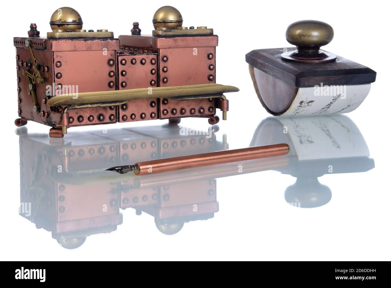 Close-up of copper inkwell and ink pen a on a white background. Style Steampunk. Stock Photo