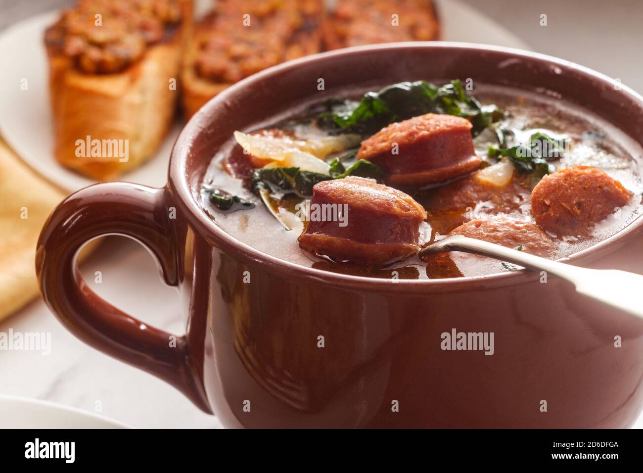 Traditional Portuguese caldo verde chourico soup with and petiscos Stock Photo