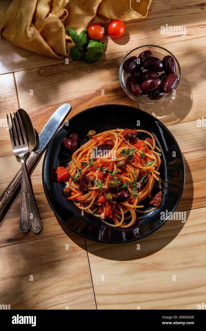 Delicious Italian spaghetti alla puttanesca with kalamata olives and