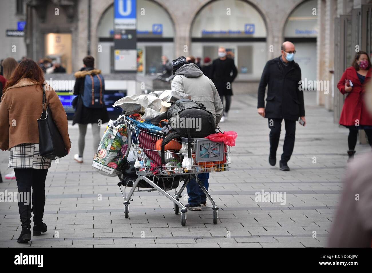 Ten years picture Prey Munich. 15th Oct, 2020. Public life in times of the coronavirus pandemic on  October 15, 2020 in Munich. A homeless, poor, bum drives his belongings,  which are in a shopping cart, through