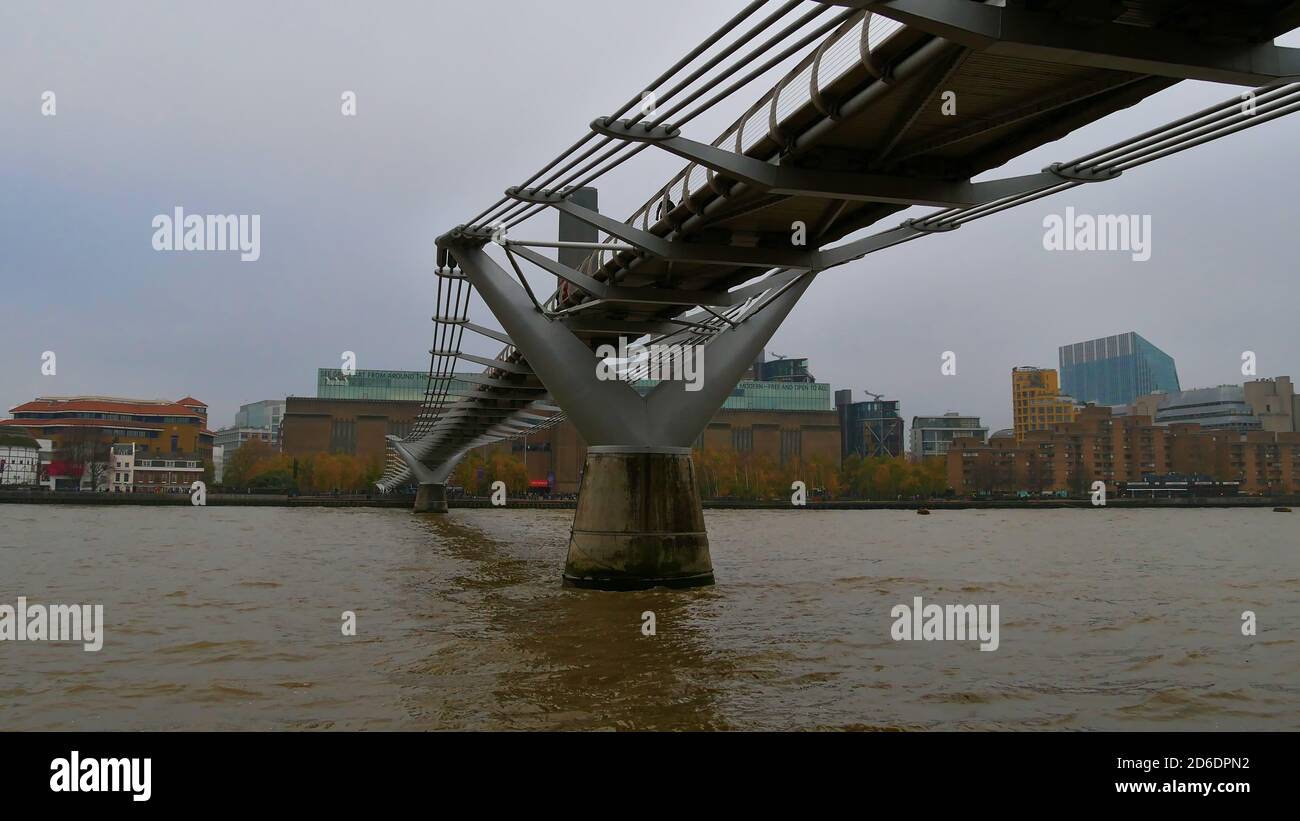 London, UK - 11/23/2018: View from below of suspension bridge Millennium Bridge (London Millennium Footbridge), spanning Thames River. Stock Photo
