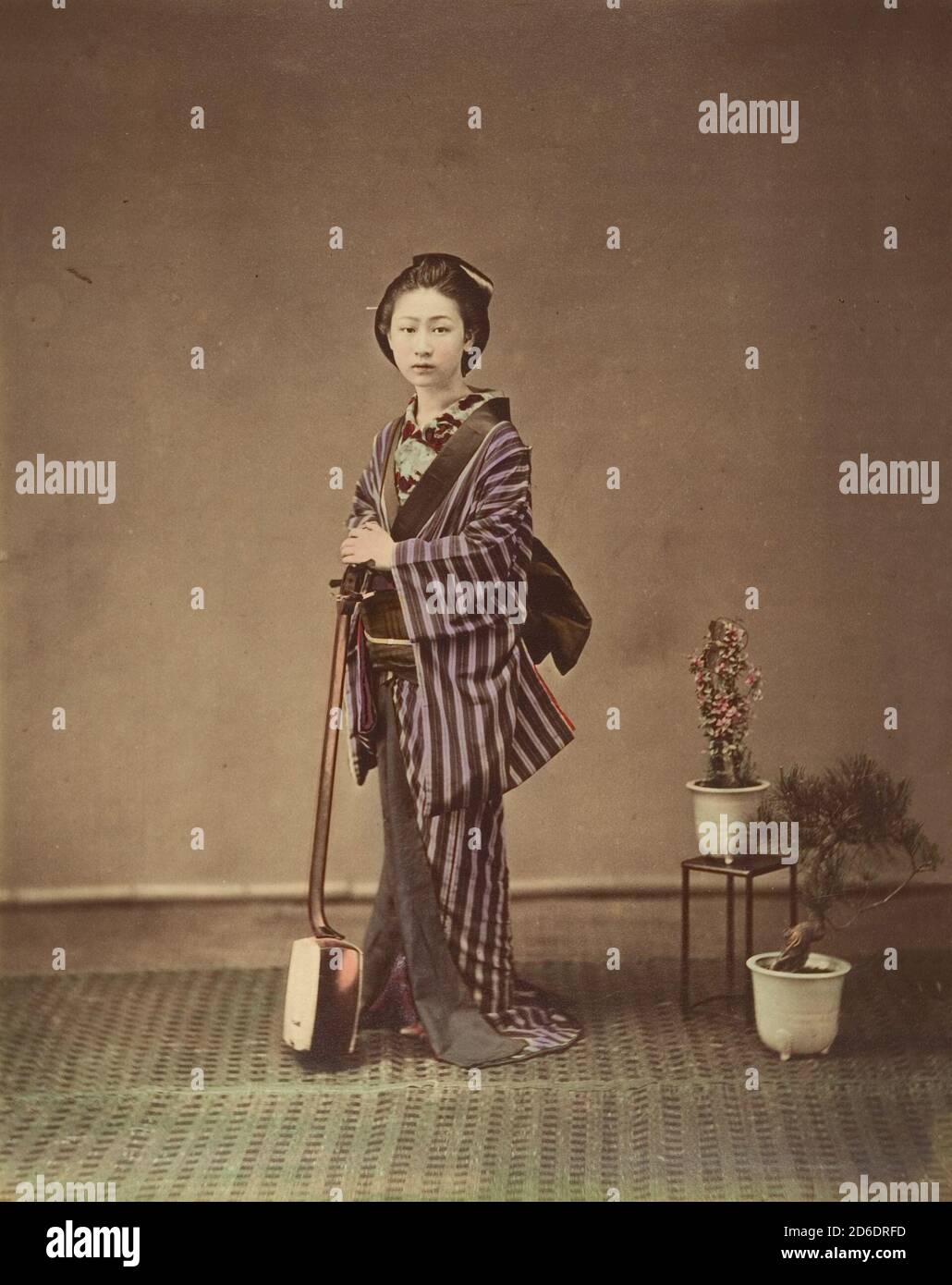 Japanese Woman In Traditional Dress Posing With Instrument 1870s japanese-woman-in-traditional-dress-posing-with-instrument-1870s