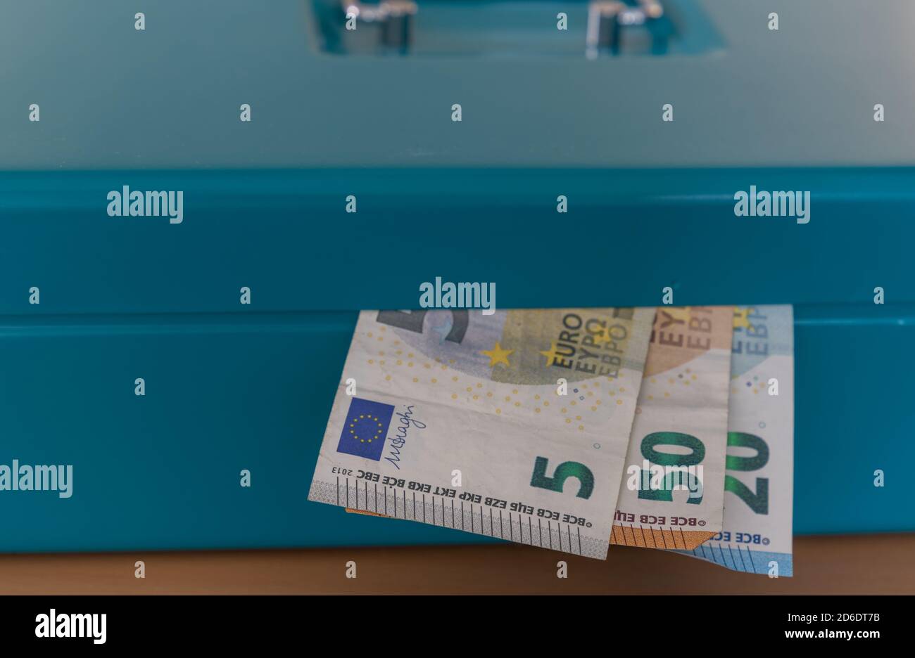 Close-up of three European banknotes in a closed cash box. Stock Photo