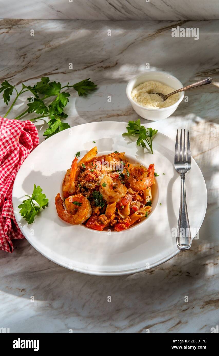 Authentic Italian dinner penne ragu alla bolognese with tailon shrimp