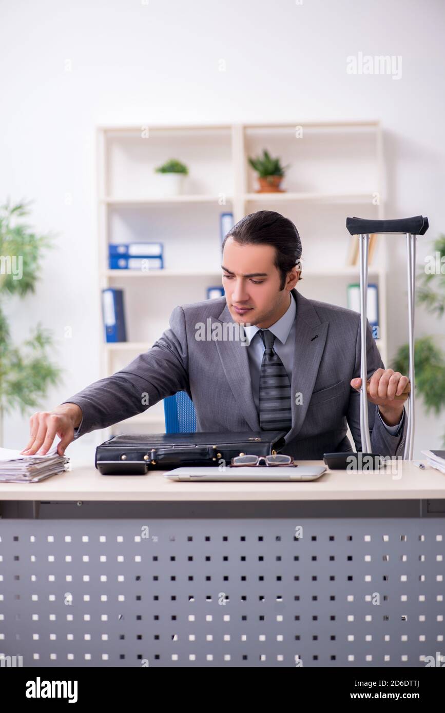 Young employee after accident at workplace Stock Photo