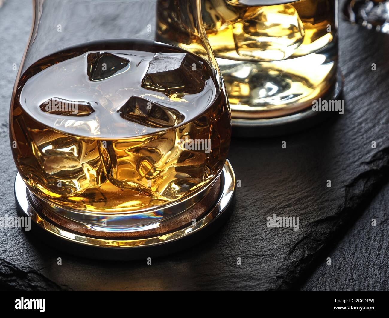 Whisky on the rocks on a black slate surface Stock Photo Alamy