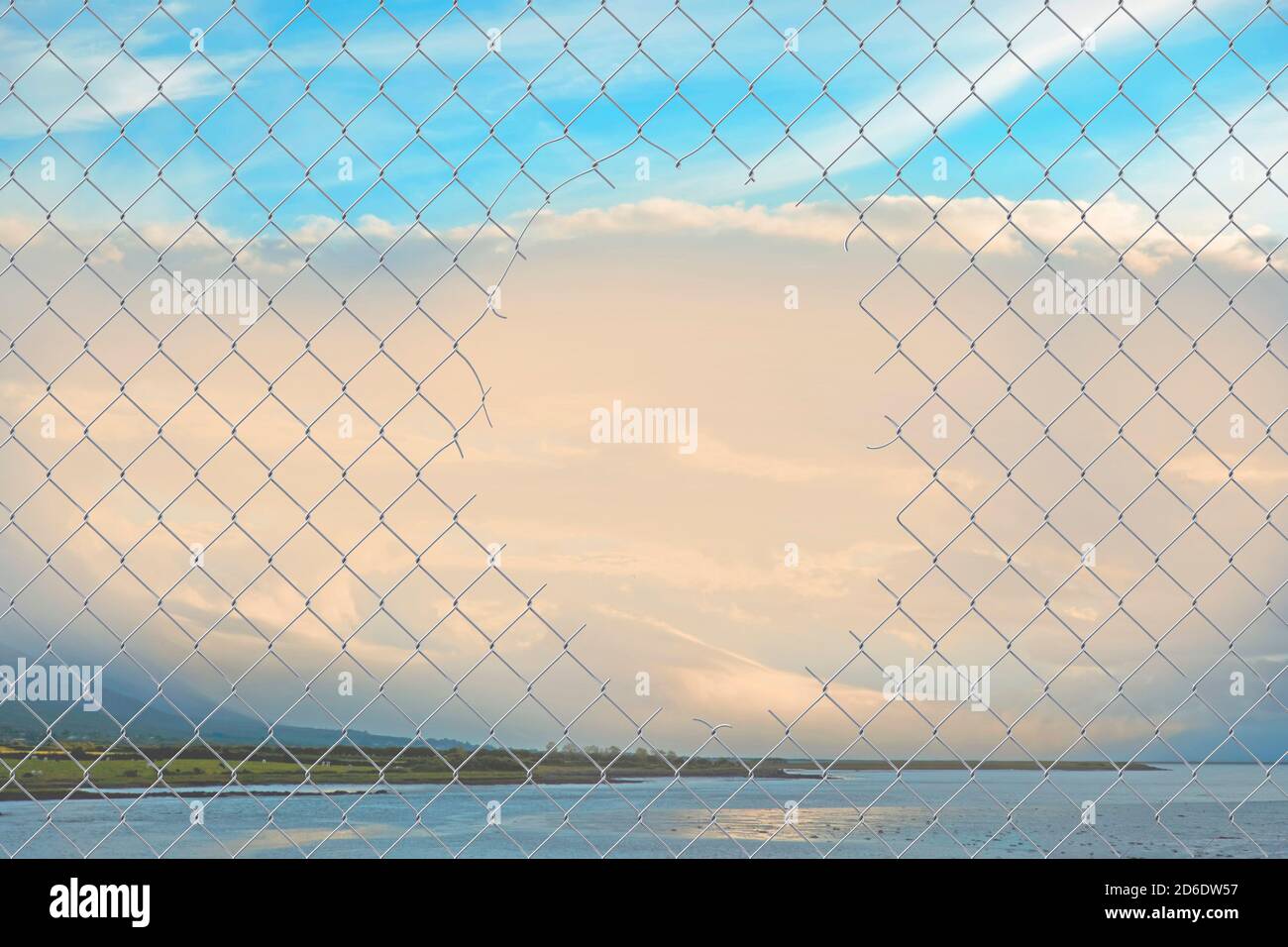 Hole in a chain link fence Stock Photo Alamy