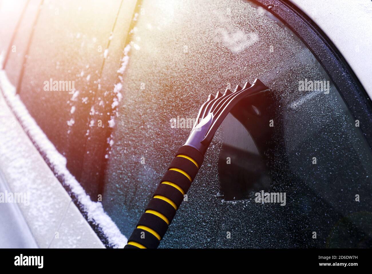 Hand scratching ice from car window. Ice scraper Stock Photo Alamy