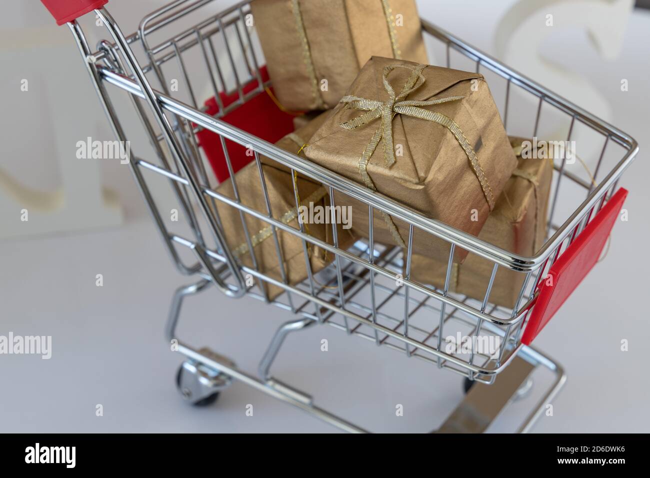 gifts in a little shopping cart as a concept for expensive gifts in christmas time Stock Photo