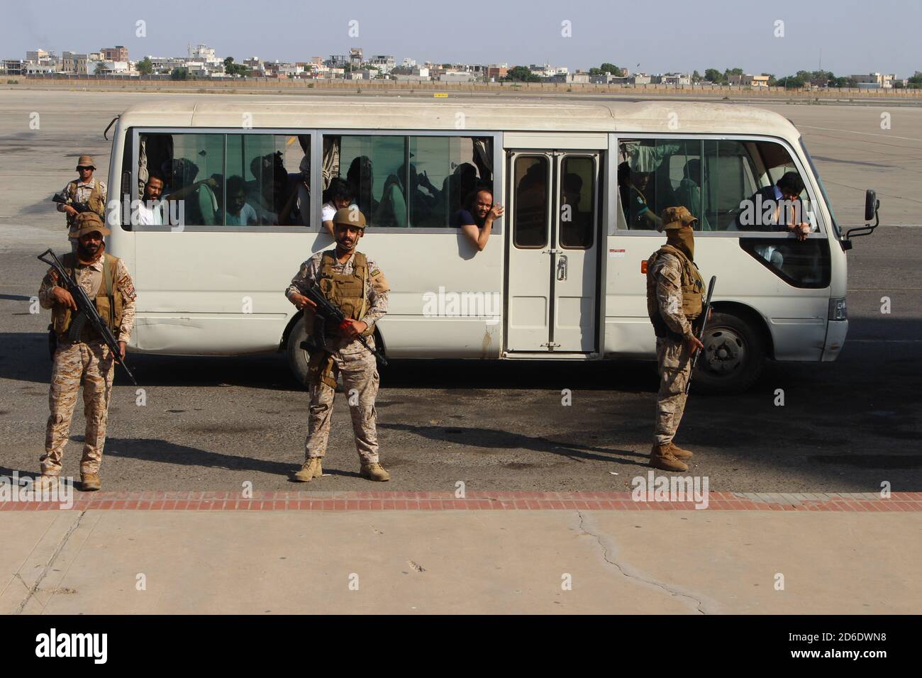 Aden, Yemen. 16th Oct, 2020. Saudi soldiers stand guard of a bus carrying Yemeni Houthi prisoners at an airport in the southern city of Aden, on the second day of a prisoner swap between the Yemeni government and the Houthi movement. More than 1,000 people detained in relation to the conflict in Yemen are to be transported back to their region of origin or to their home countries by The International Committee of the Red Cross (ICRC) in the largest operation of its kind during the five-and-a-half-year war. Credit: Wail Shaif/dpa/Alamy Live News Stock Photo