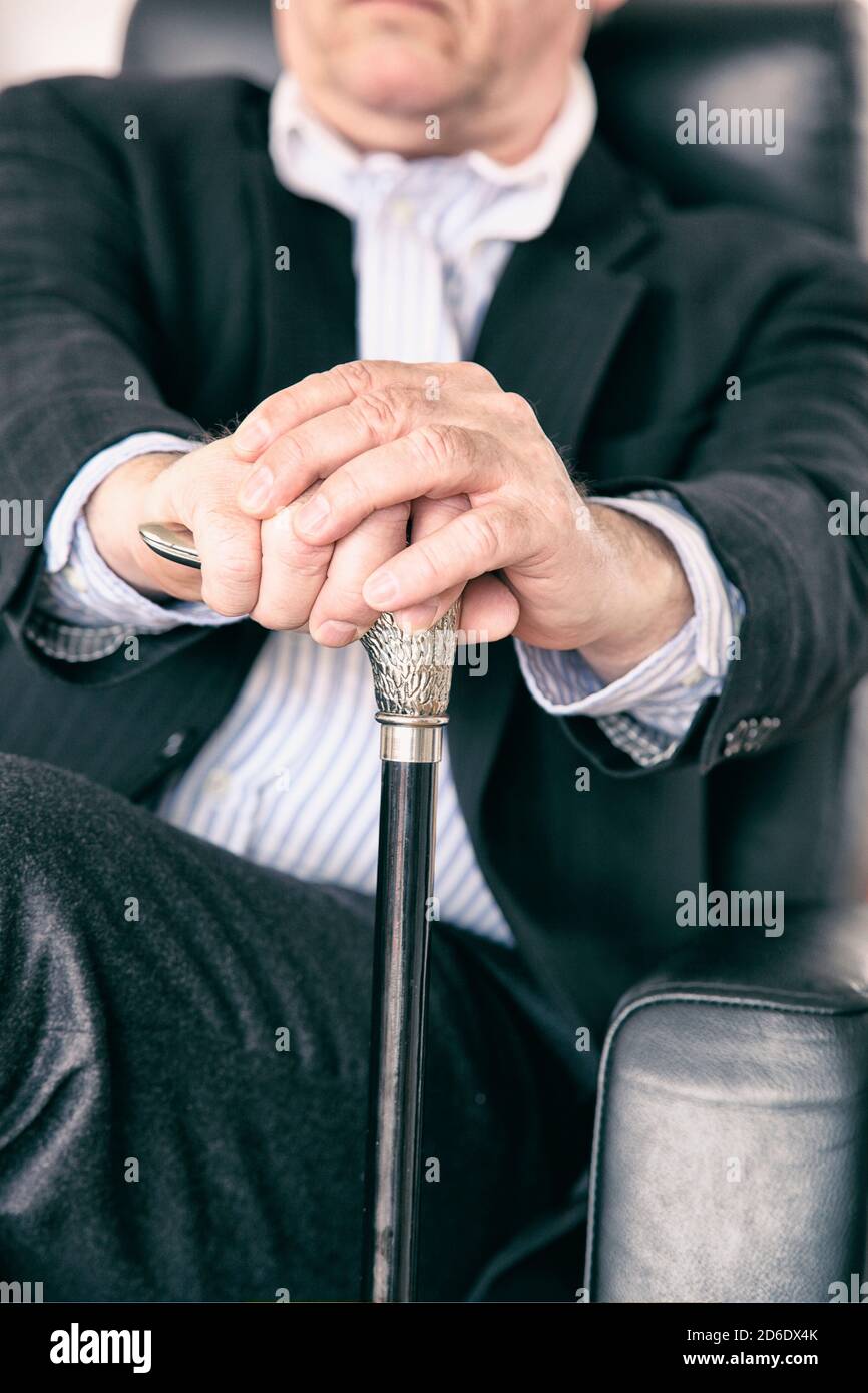 Pensioner with walking stick, sitting, closeup, detail Stock Photo Alamy