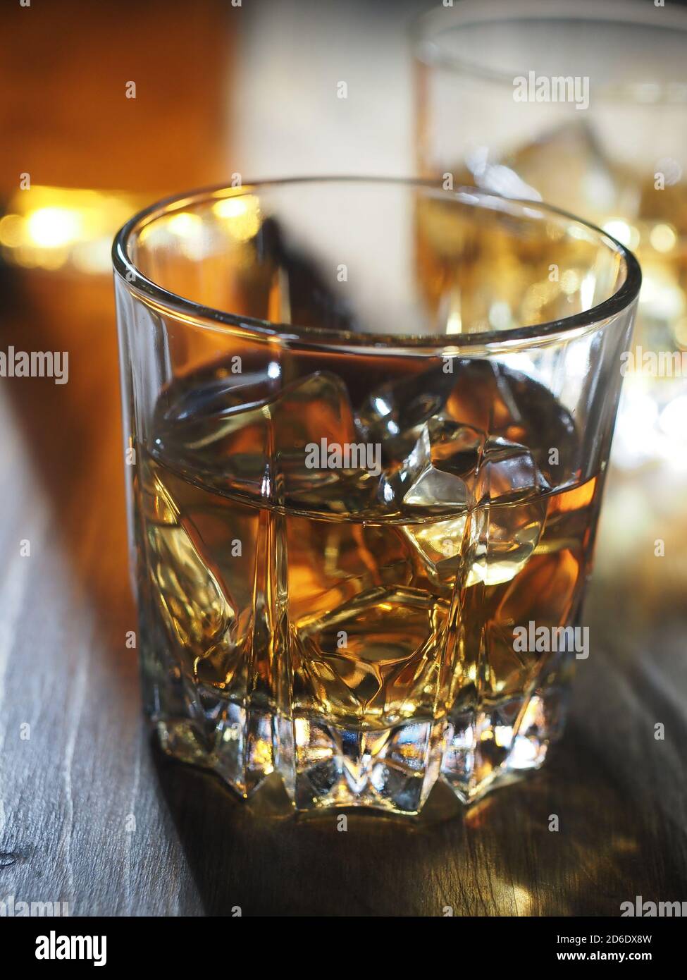 Two glasses of whisky on the rocks on a wooden table Stock Photo - Alamy