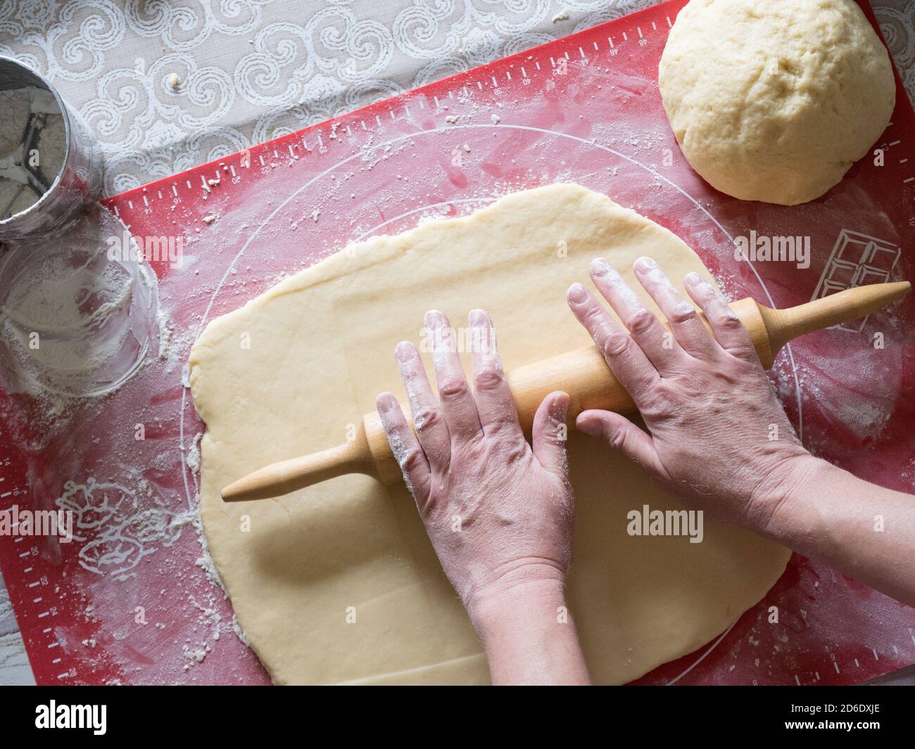 Woman's hands rolling dough, cooking at home Stock Photo - Alamy