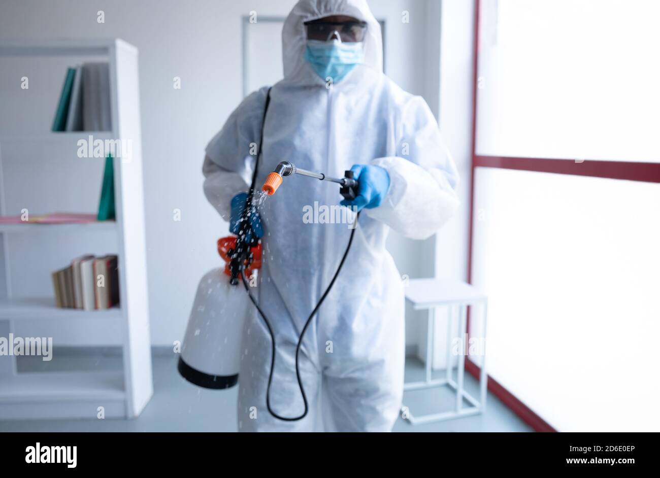 Health worker wearing protective clothes cleaning using disinfectant Stock Photo