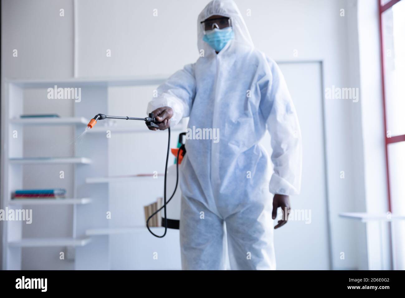 Health worker wearing protective clothes cleaning using disinfectant Stock Photo