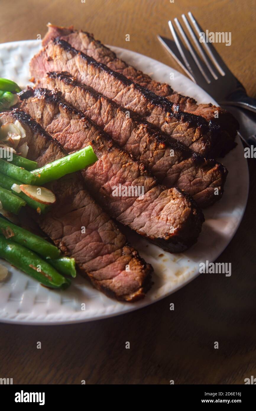 Filet mignon steak dinner with green string beans in almond butter sauce Stock Photo