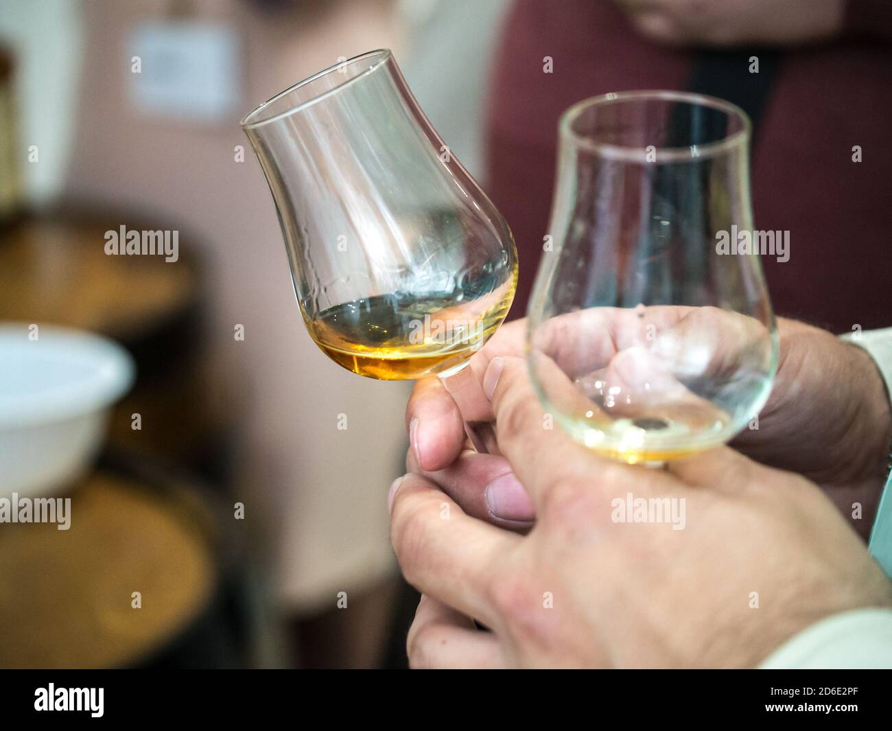 Hand holding a snifter glass filled with whisky, whisky tasting event Stock Photo Alamy