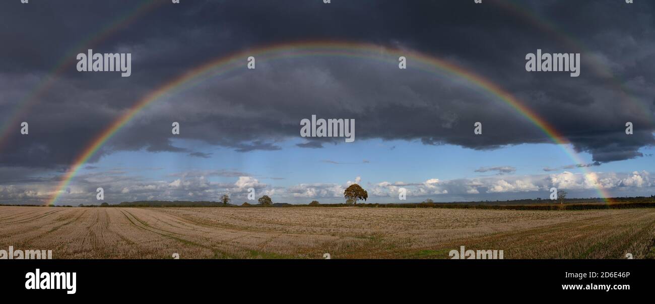 Double rainbow over Lincolnshire stubble field arable landscape showing Alexander's Dark Band an optical phenomenon caused by diffraction of light Stock Photo