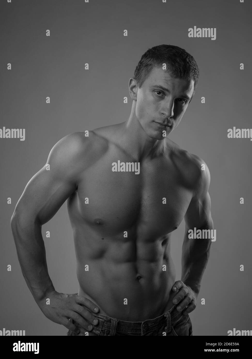 Muscular and fit young man posing shirtless Stock Photo - Alamy