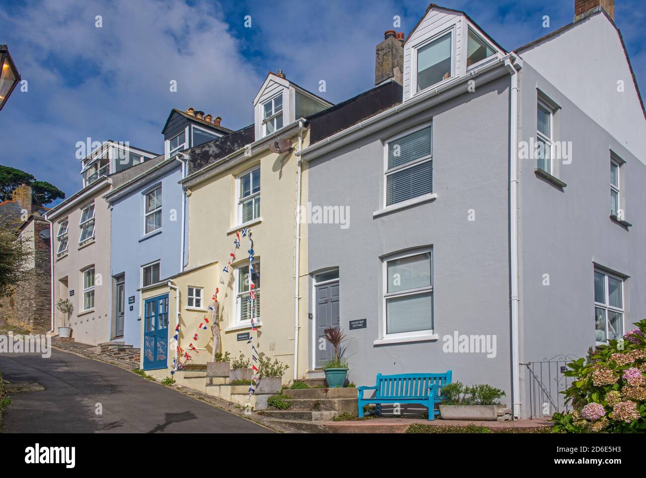 Four colourful pretty terraced house on steep street Fowey Norfolk England Stock Photo