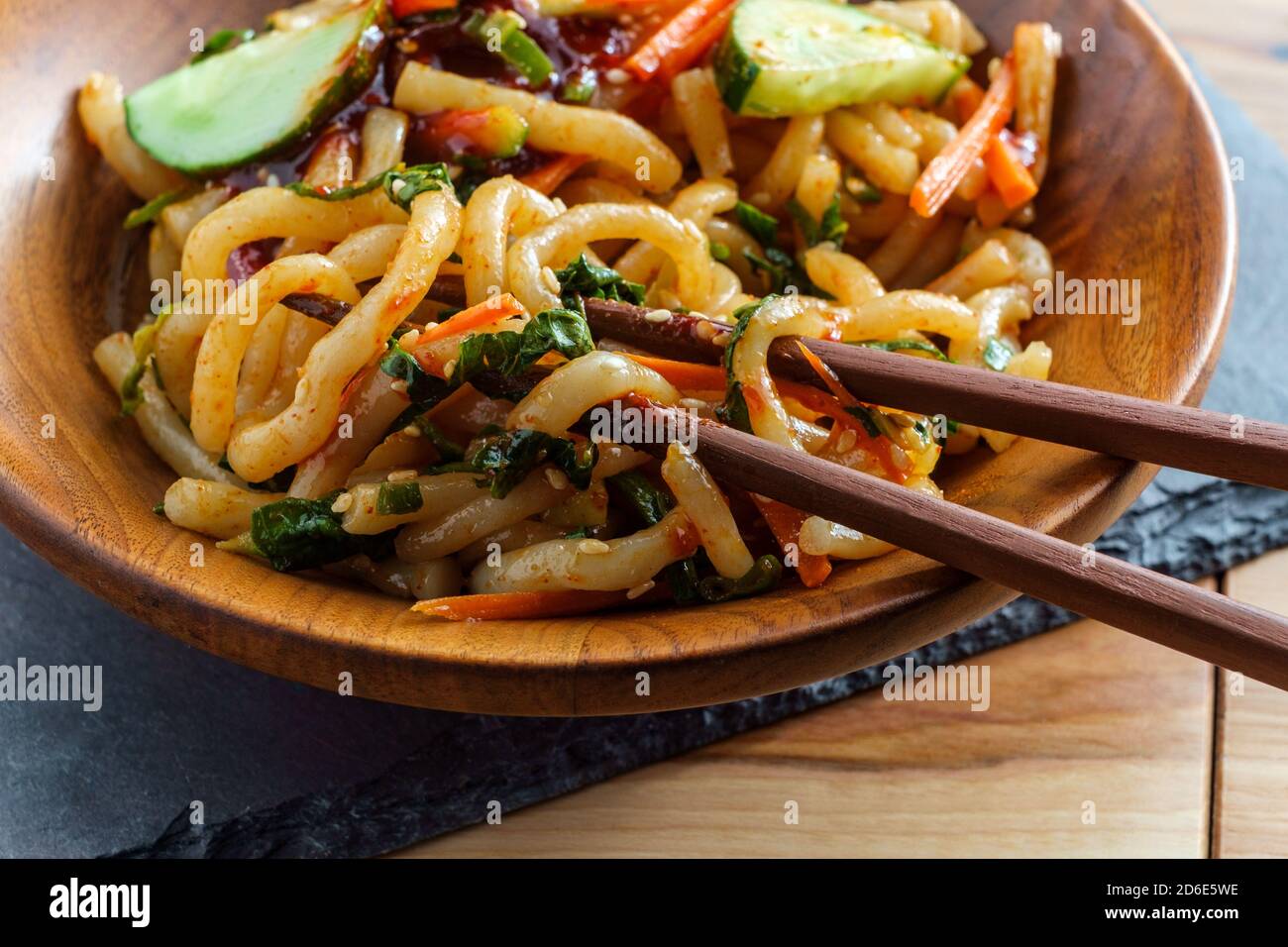 Stirfried kimchi udon noodle bokkeum with fresh kirby cucumber carrots and gochujang sauce