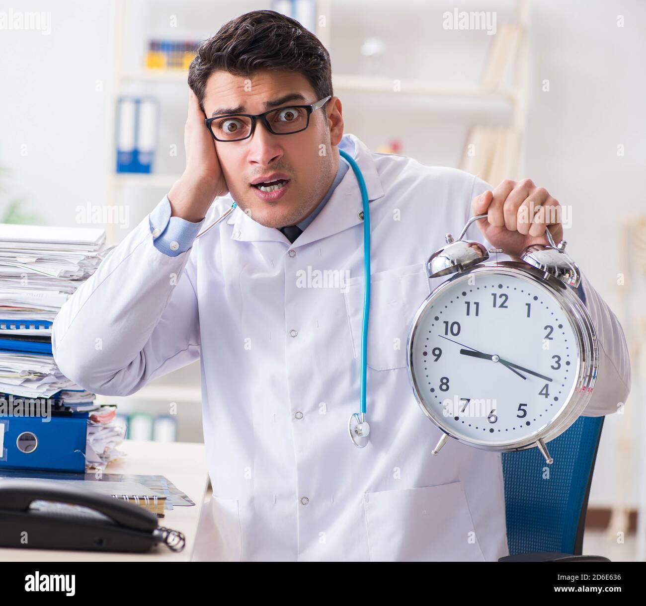 The doctor with alarm clock in urgent check-up concept Stock Photo - Alamy