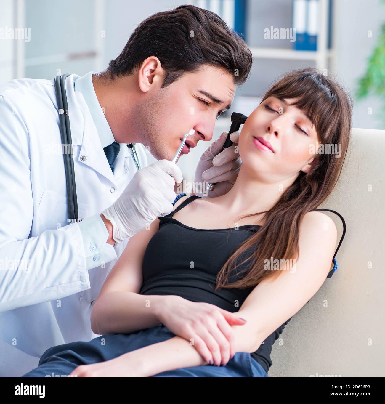 The doctor checking patients ear during medical examination Stock Photo ...
