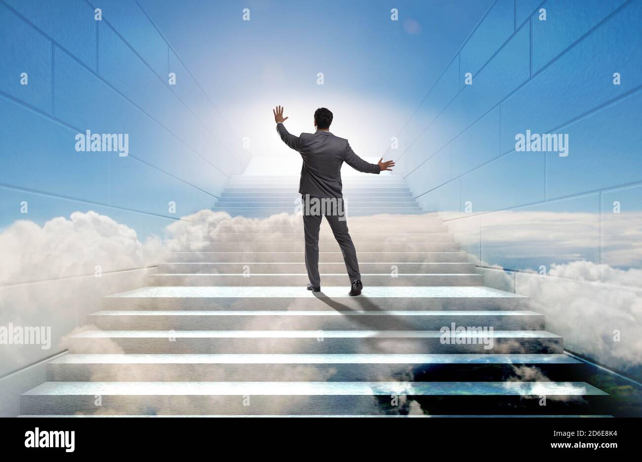 Businessman climbing up challenging career ladder in business concept ...