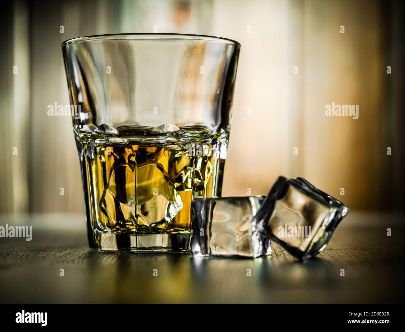 Glass of whiskey on the rocks on a wooden background Stock Photo - Alamy
