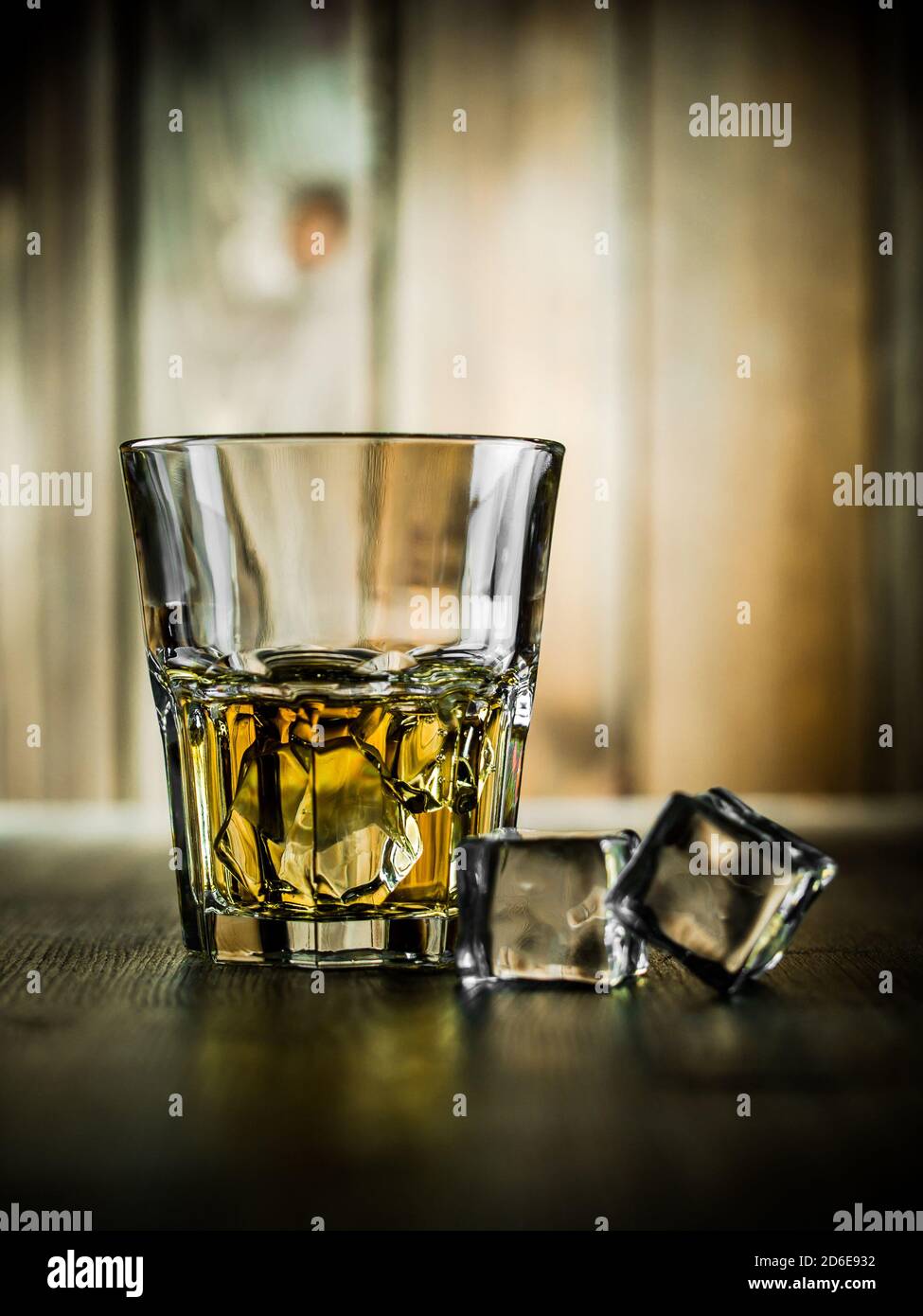 Glass of whiskey on the rocks on a wooden background Stock Photo - Alamy