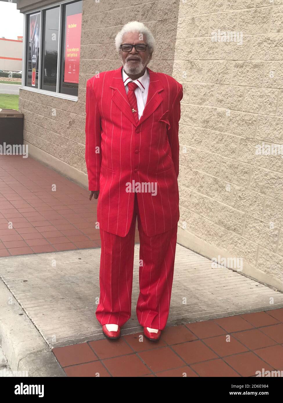 Black man looking stylish  in red suit Stock Photo