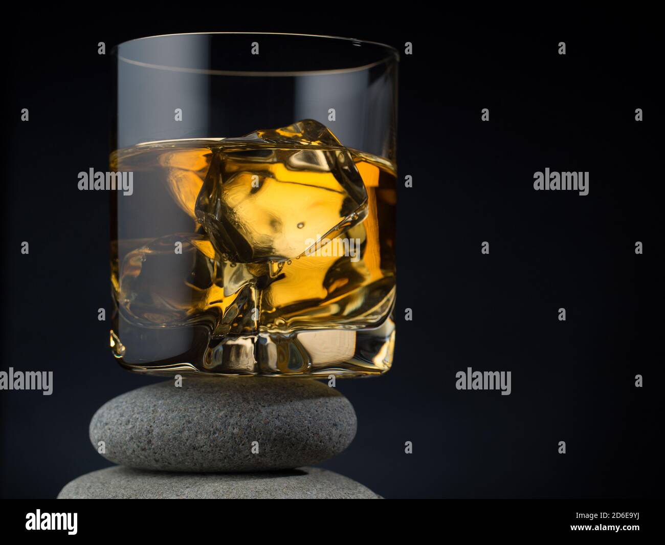 Glass of whiskey on the rocks standing on a pile of stones Stock Photo ...