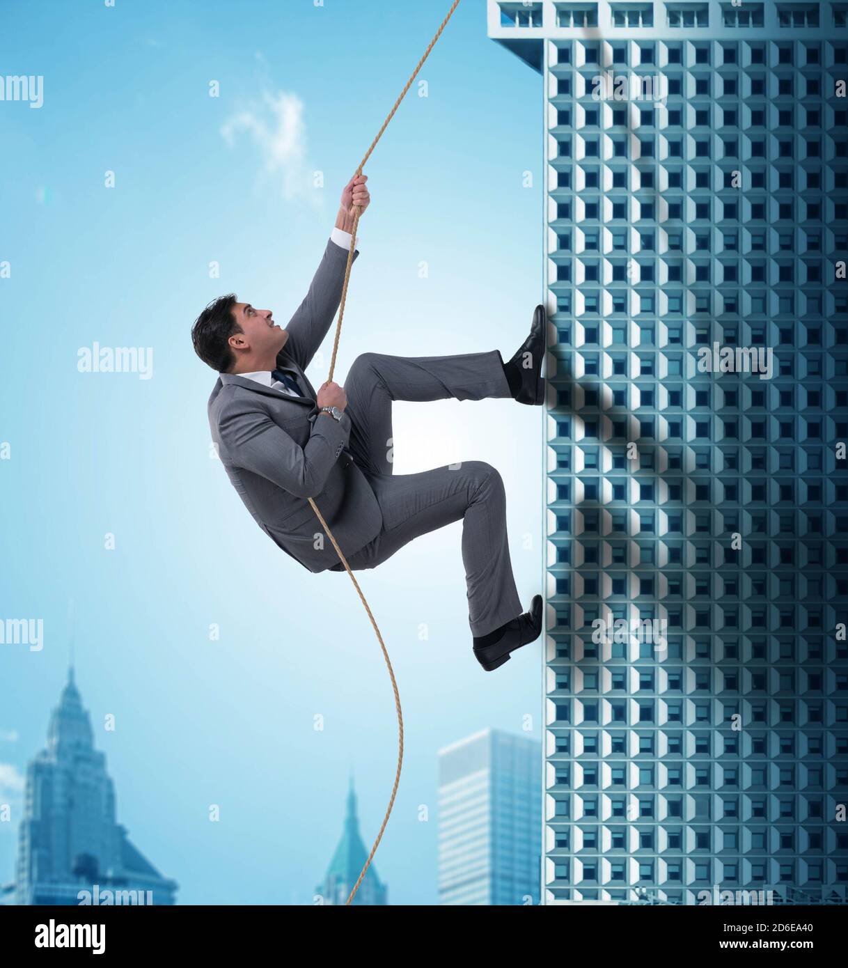 The businessman climbing skyscraper in challenge concept Stock Photo
