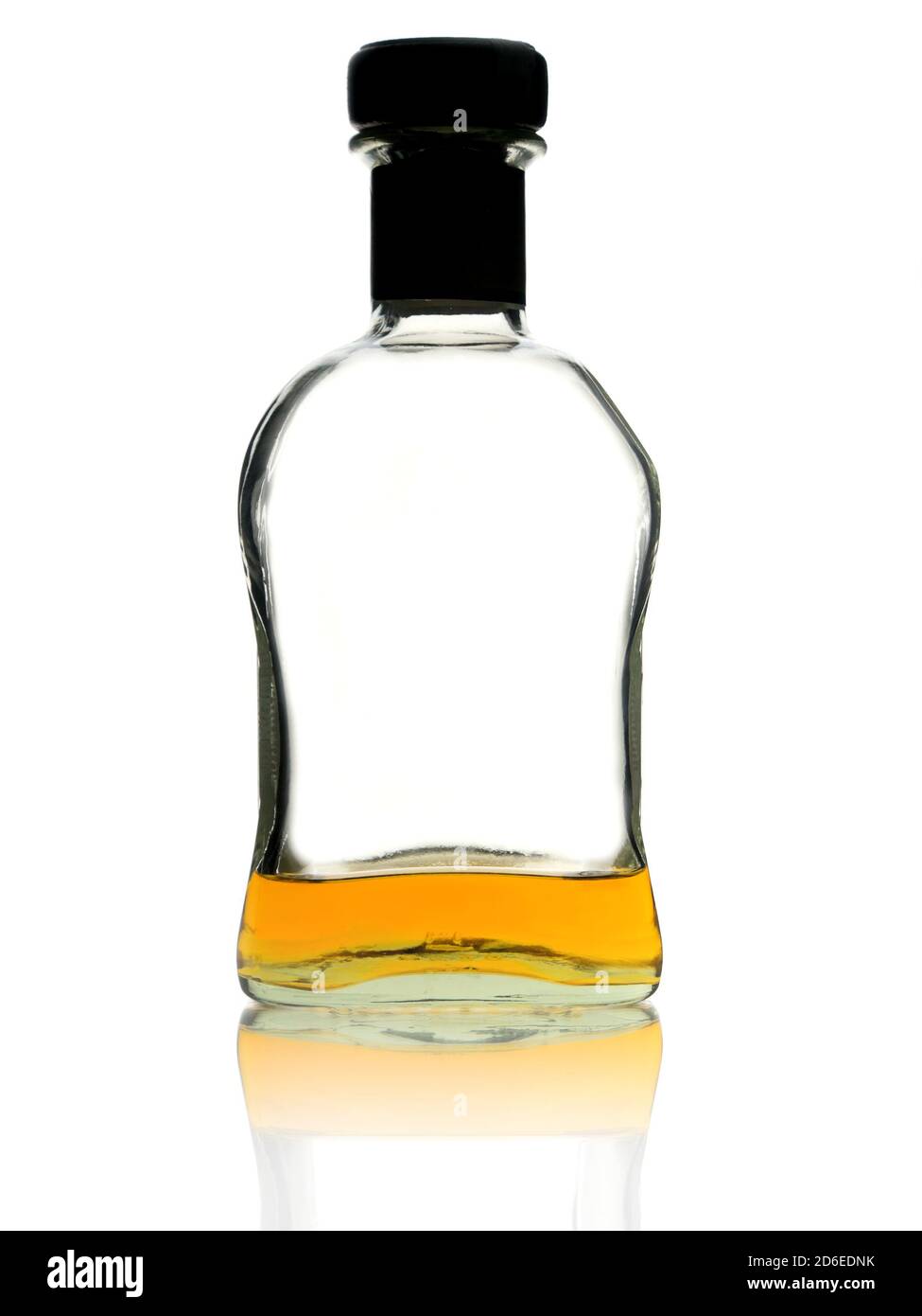 Almost empty whiskey bottle on white background Stock Photo