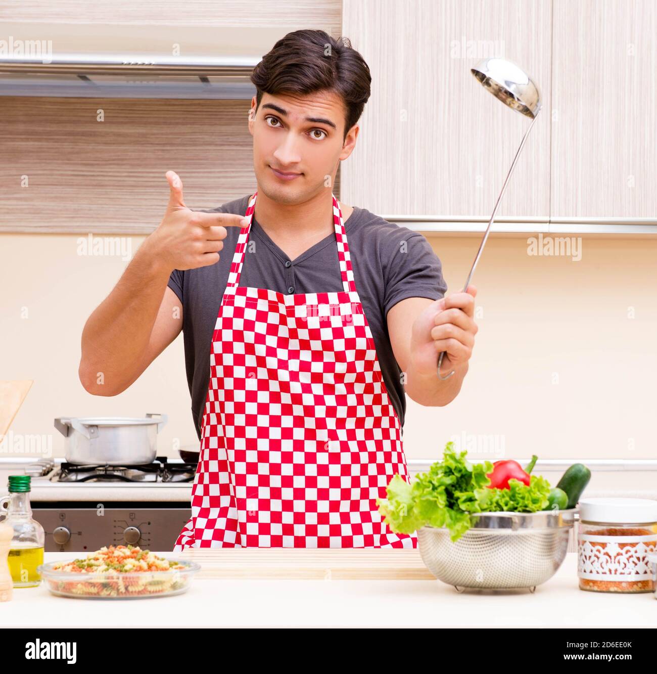 The man male cook preparing food in kitchen Stock Photo - Alamy