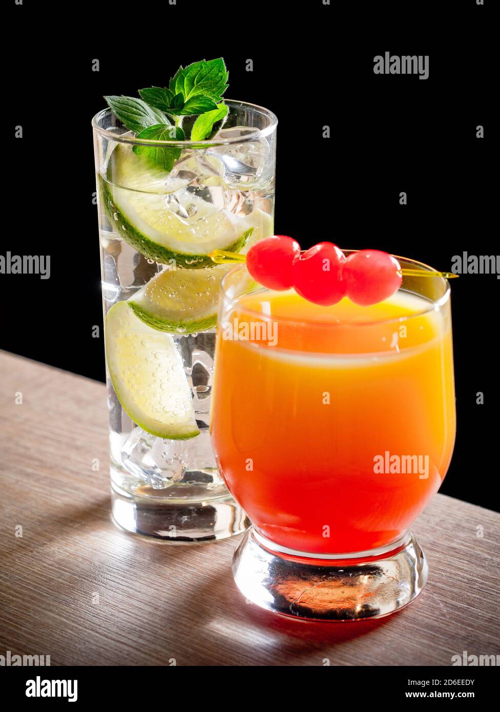 Two cocktails, tequila sunrise and gin and tonic Stock Photo Alamy