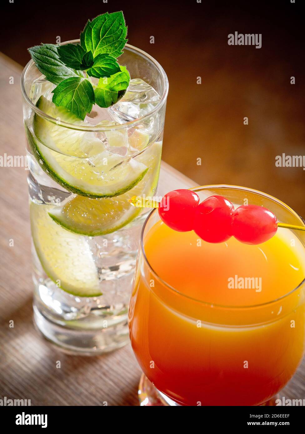 Two cocktails, tequila sunrise and gin and tonic Stock Photo Alamy