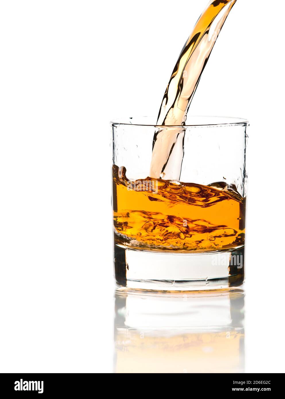 Pouring whiskey in a clear glass, on white background Stock Photo Alamy