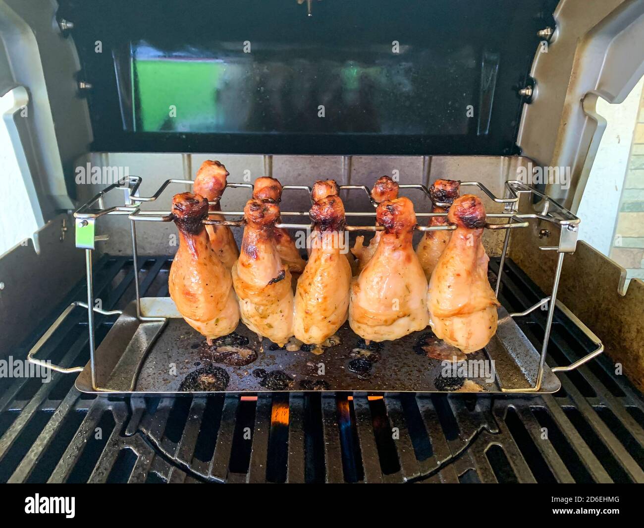 Grilled chicken drumsticks are cooked in gas grill Stock Photo Alamy