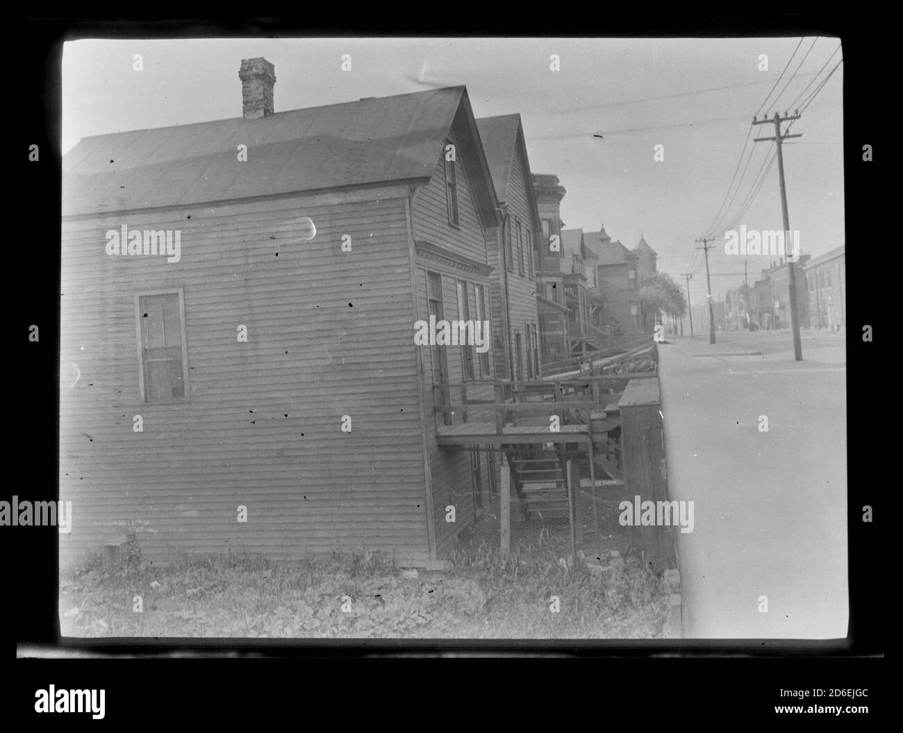 Unidentified frame houses showing the difference in level from the street to the houses, Chicago, Illinois. Stock Photo