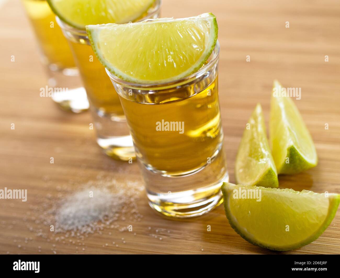 Three shots of tequila with lime and salt Stock Photo - Alamy