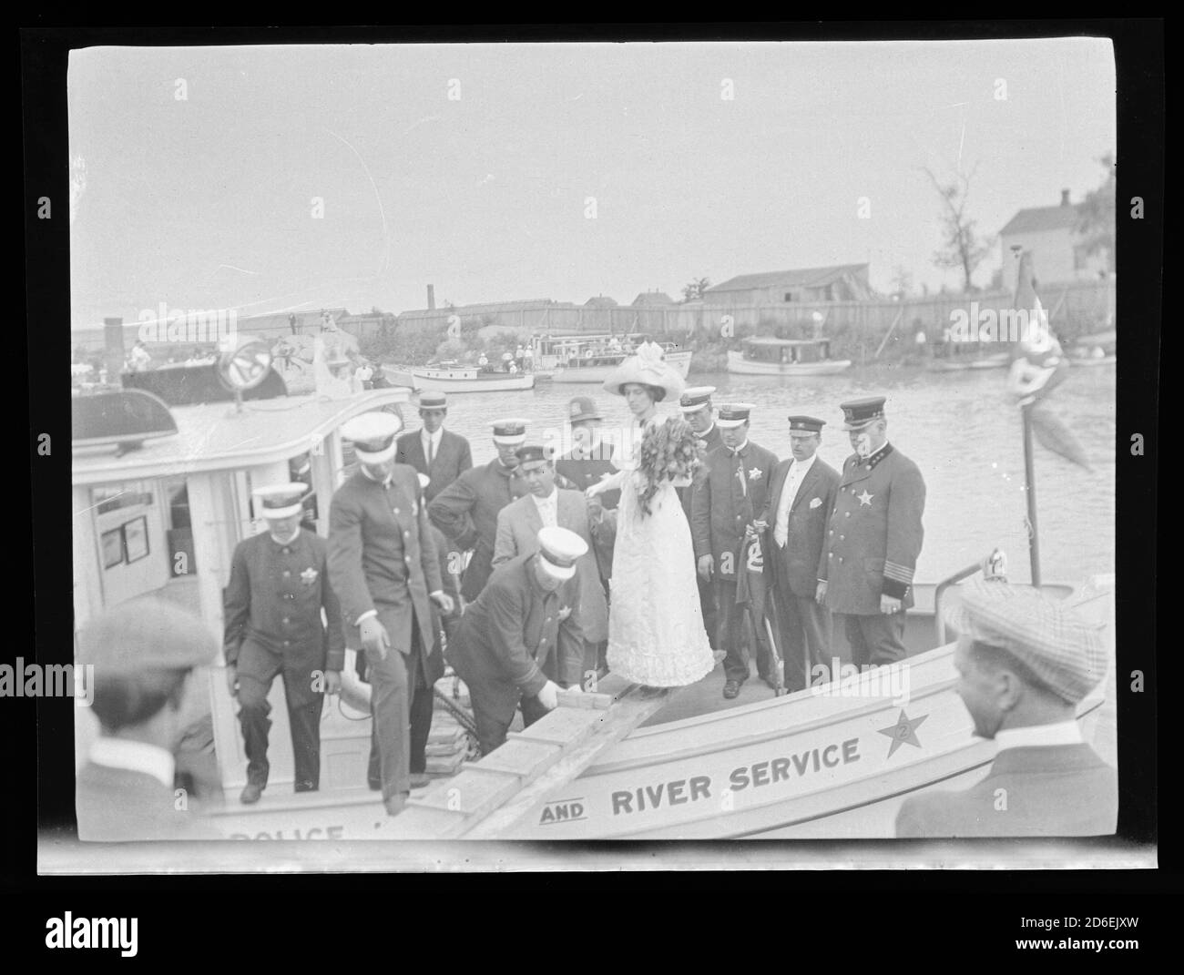 Disembarking of Miss McWeeney, daughter of Chicago Police Chief John McWeeney, from a newly launched police boat,  Chicago, Illinois, August 4, 1912. Stock Photo