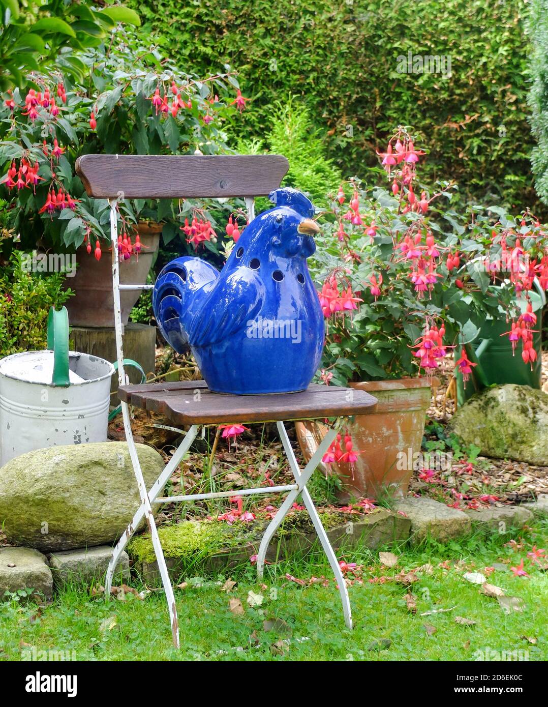 Ceramic garden decoration, blue bird on the chair Stock Photo