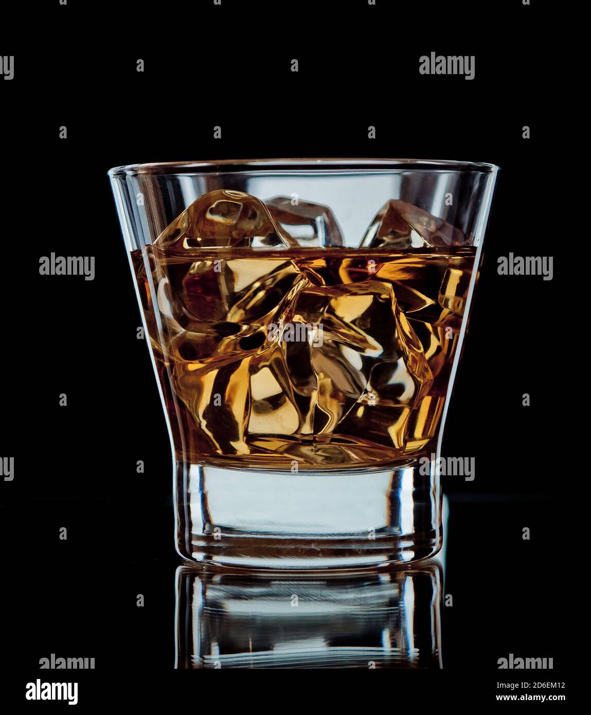 Glass of whiskey on the rocks on black background Stock Photo - Alamy