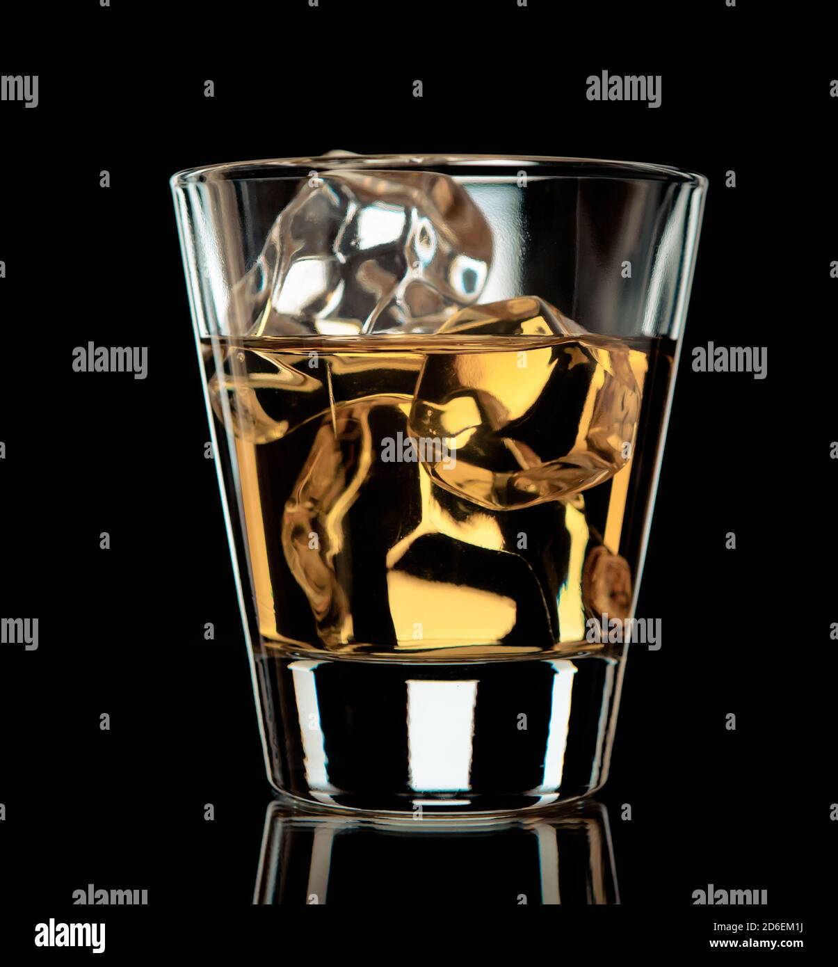 Glass of whiskey on the rocks on black background Stock Photo - Alamy