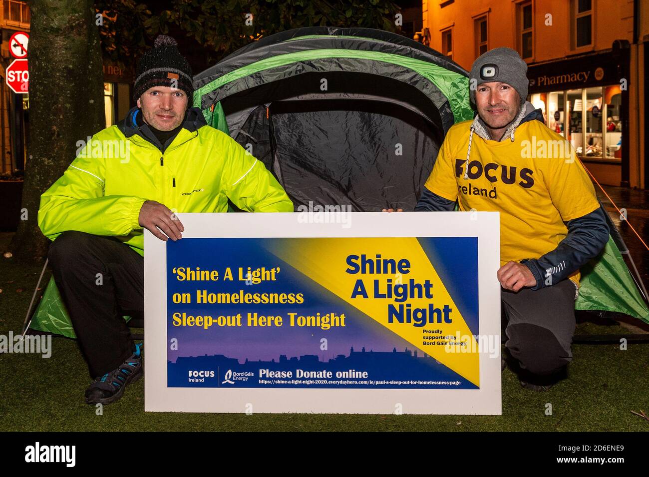 Clonakilty, West Cork, Ireland. 16th Oct, 2020. The annual Focus Ireland 'Shine A Light' sleep out in aid of homeless people is taking place virtually this year. Cllr. Paul Hayes and his brother Kevin are spending the night in a tent in Astna Square, Clonakilty. Paul and his brother will be sleeping out until 7am on Saturday morning and hope to have a full bucket of donations. Credit: AG News/Alamy Live News Stock Photo