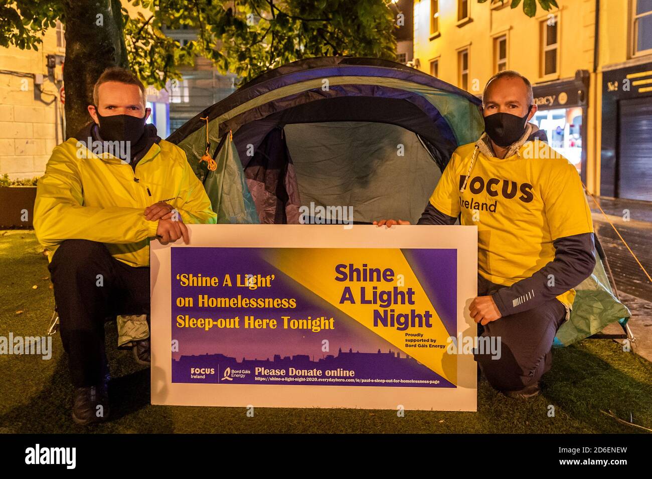 Clonakilty, West Cork, Ireland. 16th Oct, 2020. The annual Focus Ireland 'Shine A Light' sleep out in aid of homeless people is taking place virtually this year. Cllr. Paul Hayes and his brother Kevin are spending the night in a tent in Astna Square, Clonakilty. Paul and his brother will be sleeping out until 7am on Saturday morning and hope to have a full bucket of donations. Credit: AG News/Alamy Live News Stock Photo