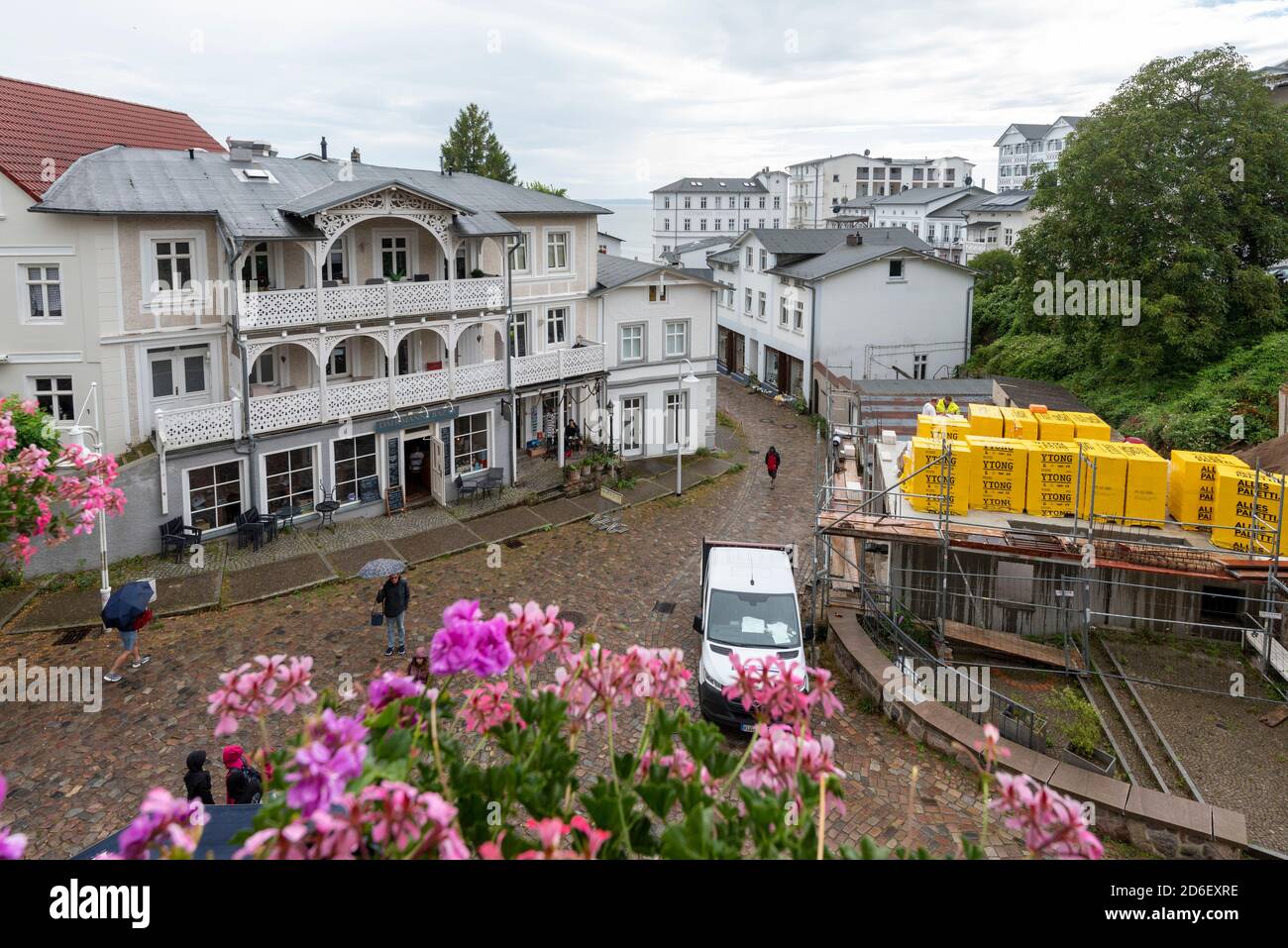 Germany, Mecklenburg-Western Pomerania, Sassnitz, yellow aerated concrete blocks lie on the roof of a house, several hotels can be seen behind them Stock Photo